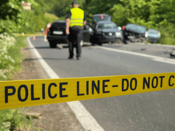 Police tape across the scene of a car accident