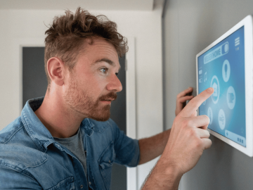 Man looking at his smart home device