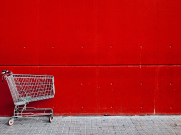 An empty trolley in front of a red wall